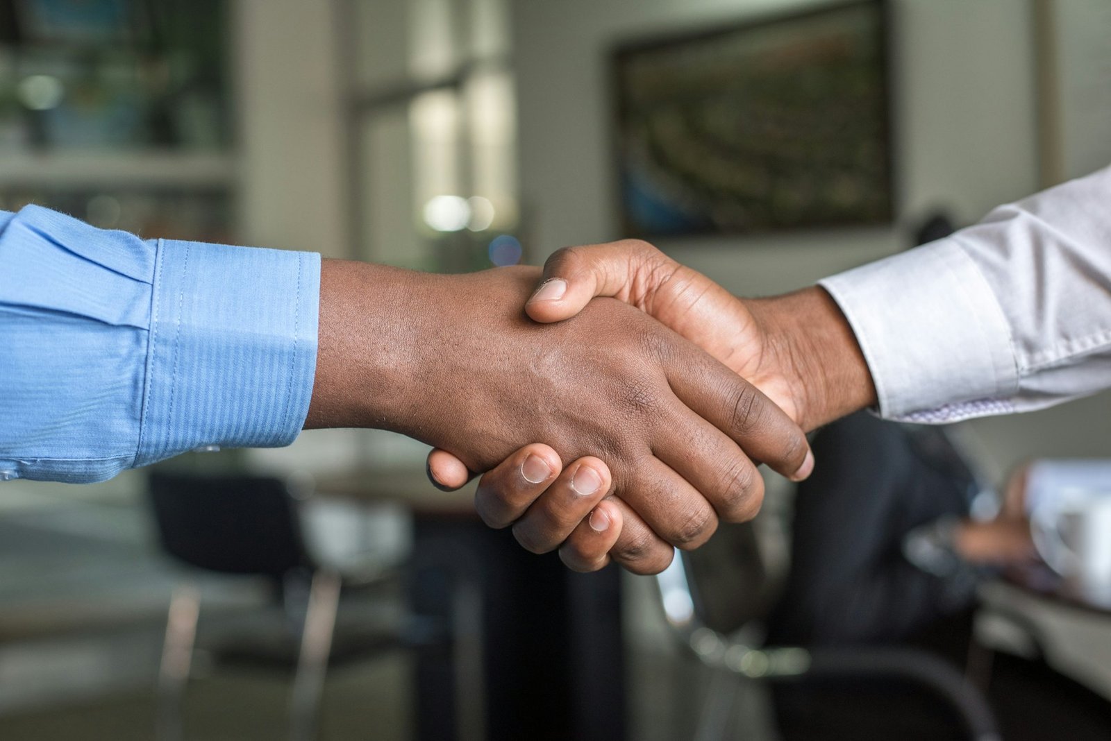 Employer and recruitment consultant shaking hands after agreeing a manpower placement